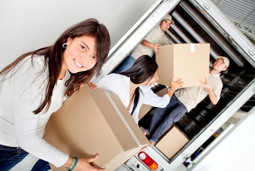 Professional team moving desks and equipment from a Shoreditch office